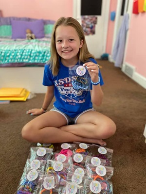 Ava on the floor with her bracelets